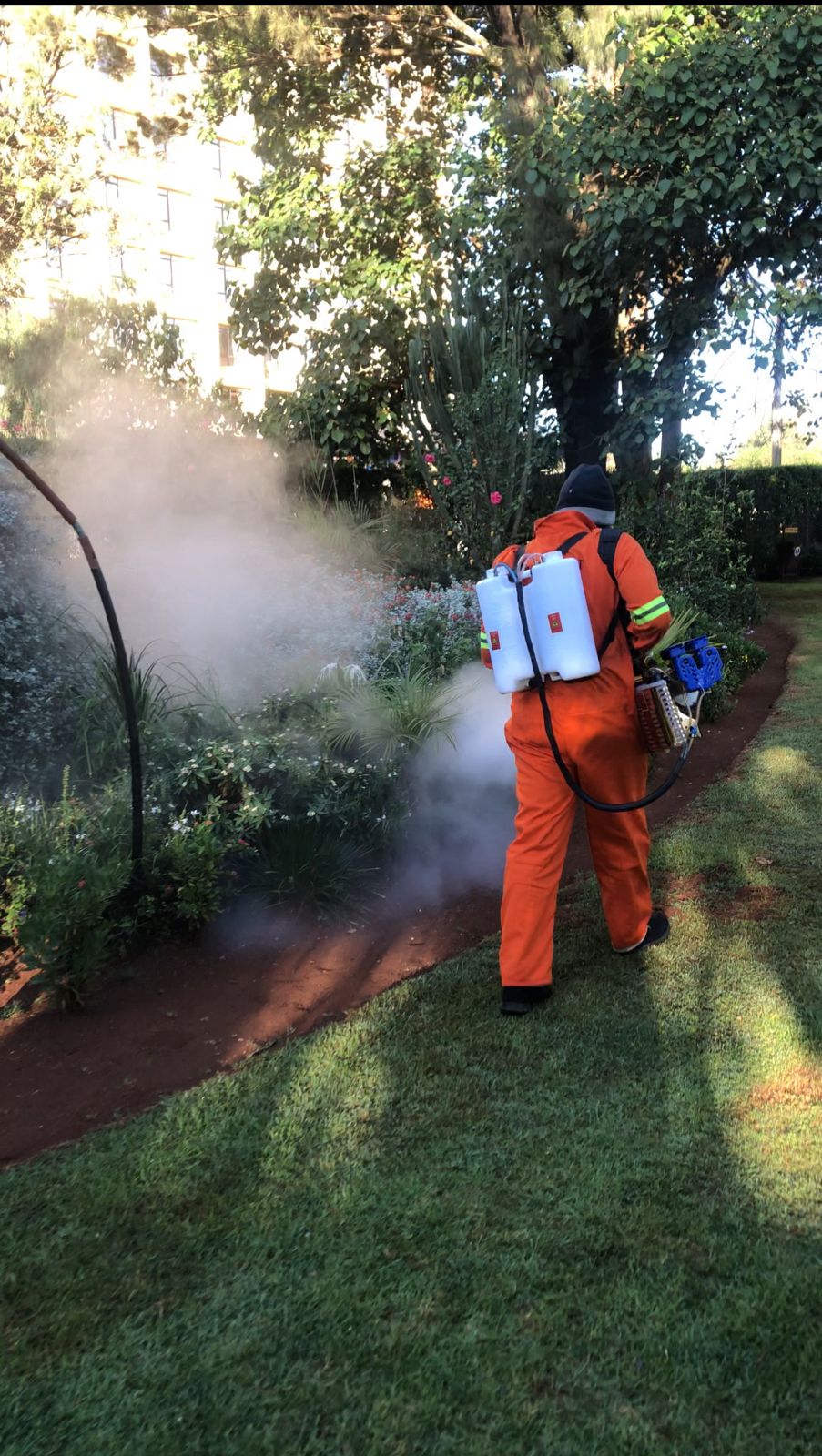 Kowa technician fogging garden perimeter